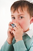 A child using an inhaler