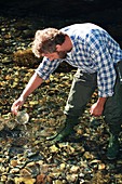 Biologist collecting a water sample
