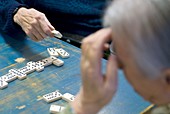 Elderly people playing dominoes