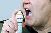 Spraying artificial saliva for dry mouth