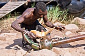 Fisherman untangling a net,Zimbabwe