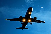 Airbus A320 airliner landing at night