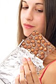 Woman eating chocolate with nuts