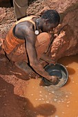 Artisan miner panning for gold,Kenya