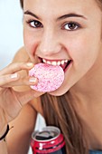 Teenage girl eating a sugary snack