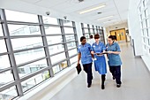 Nurses walking along hospital corridor