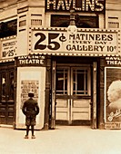 Boy reading theatre poster,1910