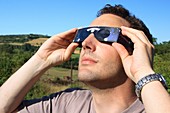 Man observing a solar eclipse