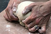 Baker kneads dough