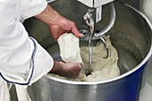 baker inspects dough