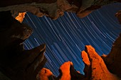 Star trails over rock formations,Iran