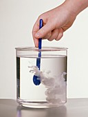 Stirring milk into water in glass beaker