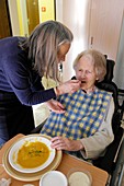 Alzheimer's patient being fed