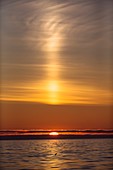 Arctic sunset with light beam