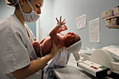 Newborn baby being weighed