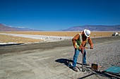 Worker digging a bore hole