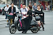 Woman on electric scooter in traffic