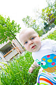 Baby boy in a garden