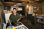 Woman cooking in a slum,Mexico