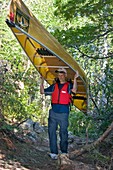 Man carrying a canoe