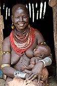 Karo woman breast feeding