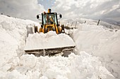 Digger clearing snow drifts