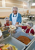 Volunteers preparing meal packages