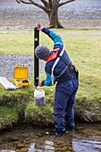 Scientist emptying sediment trap