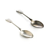 Polished and tarnished silver spoons
