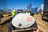 Workers washing the heliostats