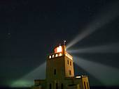 Night sky over a lighthouse