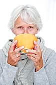 Elderly woman with a hot drink