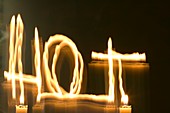 A candle flame moved to spell hot