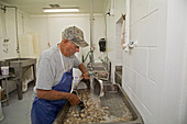 Washing processed oysters