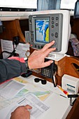 A sailor using GPS navigation equipment