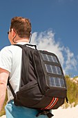 A man carrying a solar backpack