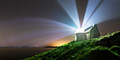 Lighthouse beams at night