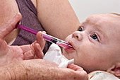 Baby receiving oral paracetamol