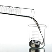 Mercury pouring from a measuring cylinder