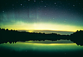 Aurora borealis display reflected upon water