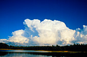 Cumulonimbus anvil clouds seen approaching lake