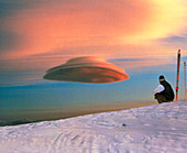 Skier looks at a lenticular cloud