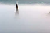 Church spire in dense fog