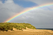 Rainbow over sand dunes