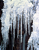 Icicles hanging off rock