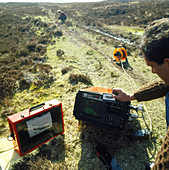 Geologists using portable seismology equipment