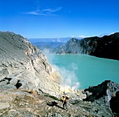 Volcanic crater lake with sulphur deposits