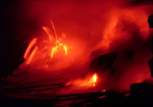 Lava entering the sea at night