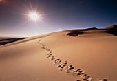 Footprints over sand dunes