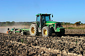 Tractor preparing a paddy field